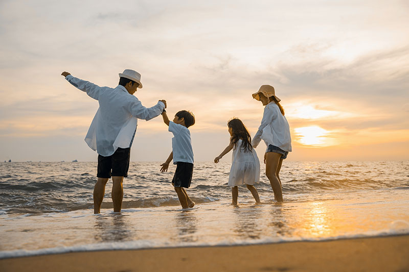 Family on beach, sunset